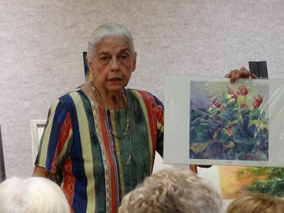 woman holding up artwork