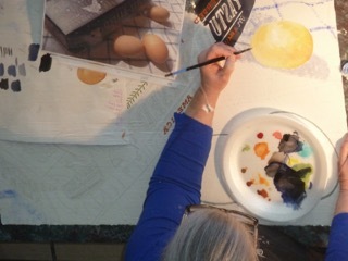 Deb paints a yellow spheroid